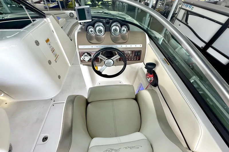 Slide: The Image of Cockpit view of 2013 Sea Ray 260 Sundeck with steering wheel and control panel. - 19