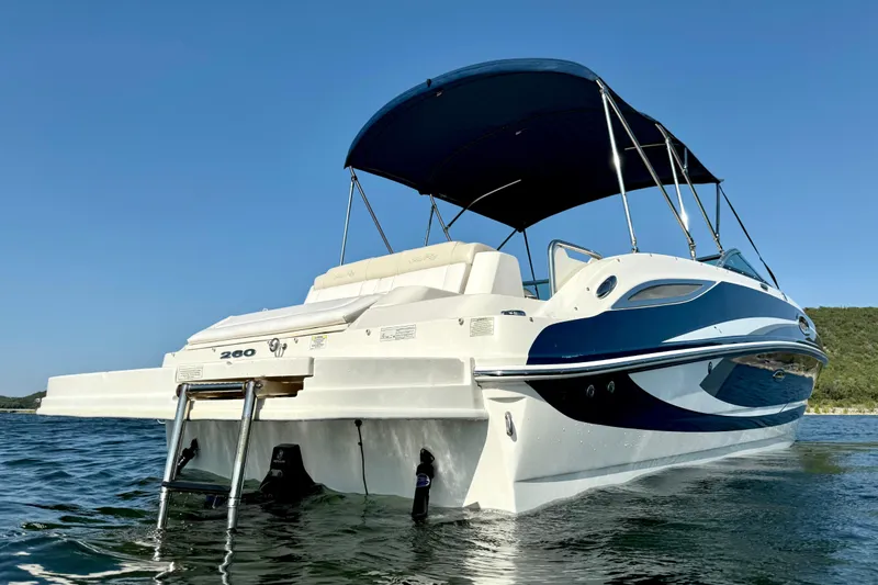 Slide: The Image of 2013 Sea Ray 260 Sundeck boat with canopy on calm water. - 3