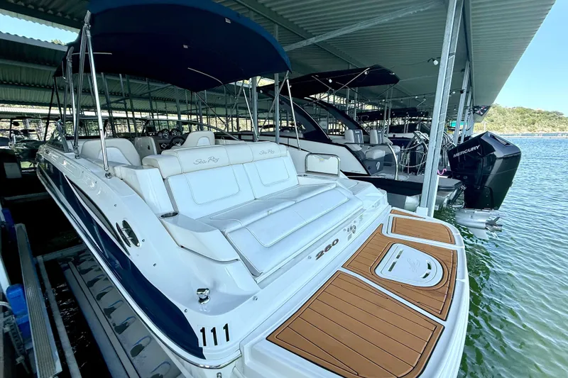 Slide: The Image of 2013 Sea Ray 260 Sundeck boat docked under a covered marina. - 9