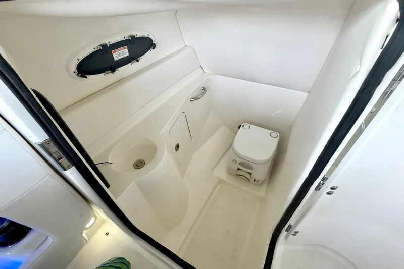 Slide: The Image of 2013 Sea Ray 260 Sundeck boat bathroom with sink and portable toilet. - 24
