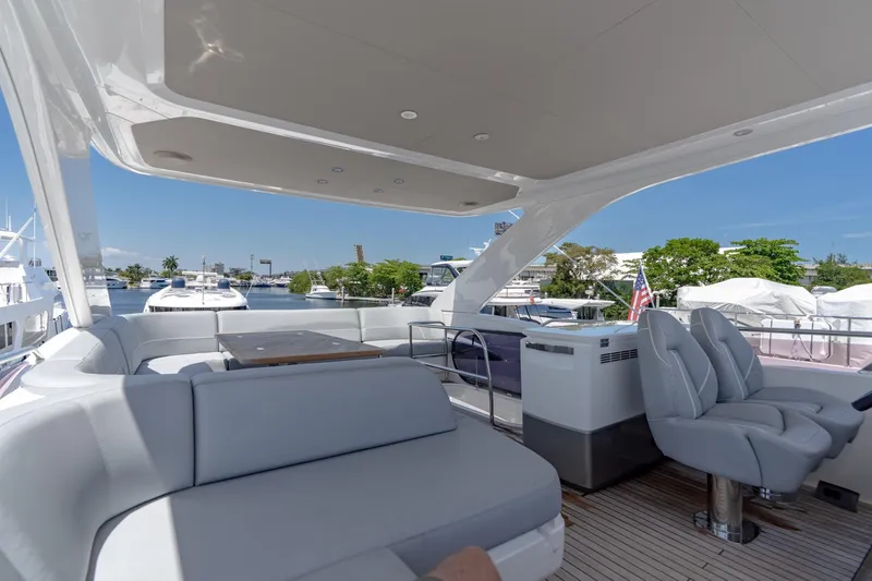 Slide: The Image of Luxurious 2021 Princess F55 yacht deck with seating and scenic marina view. - 22
