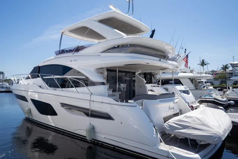Slide: The Image of Luxury 2021 Princess F55 yacht docked at marina under clear blue sky. - 35