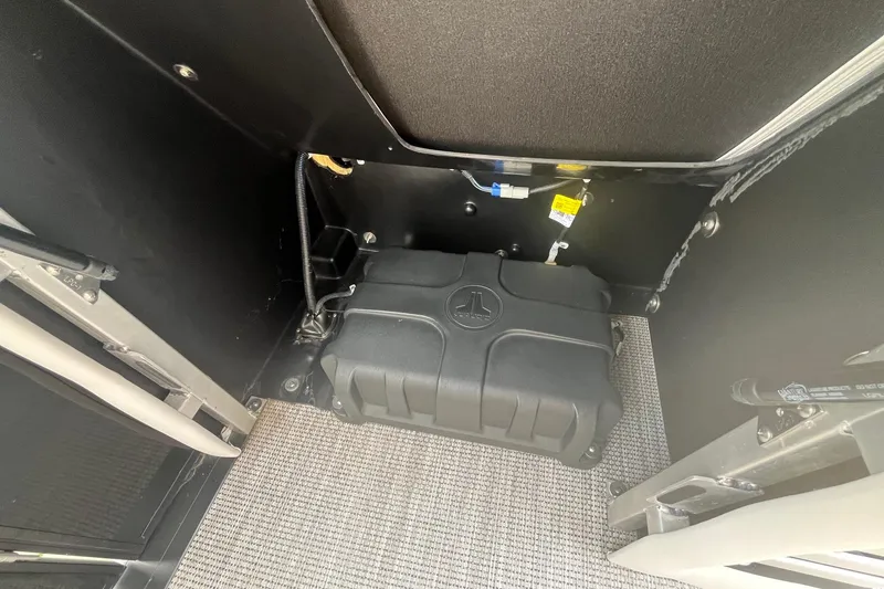 Slide: The Image of 2024 Harris Grand Mariner 250 interior showing a secured black storage compartment. - 27