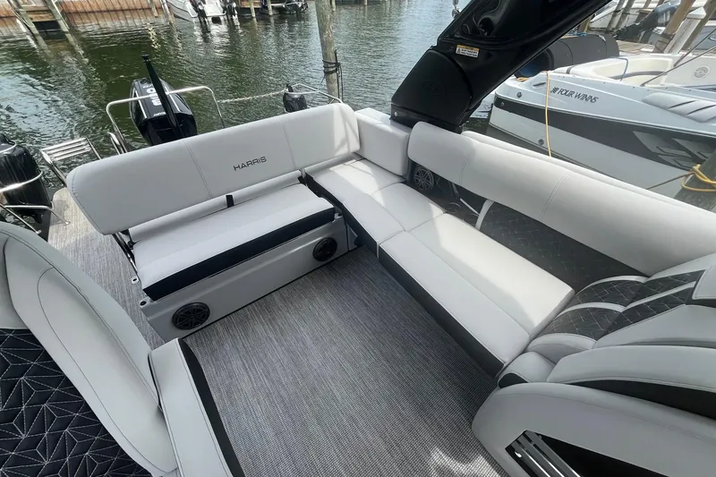 Slide: The Image of Luxurious seating on 2024 Harris Grand Mariner 250 pontoon boat, docked by the water. - 18