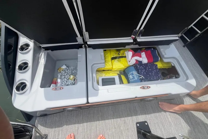 Slide: The Image of Storage compartments on a 2024 Harris Grand Mariner 250 boat, filled with supplies and accessories. - 26