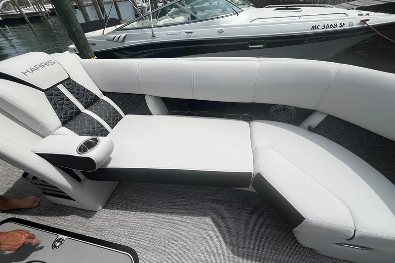 Slide: The Image of Luxurious seating on 2024 Harris Grand Mariner 250 boat, featuring sleek white and black upholstery. - 16