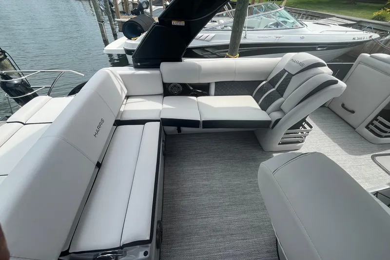 Slide: The Image of 2024 Harris Grand Mariner 250 pontoon boat interior with luxurious seating and modern design. - 17