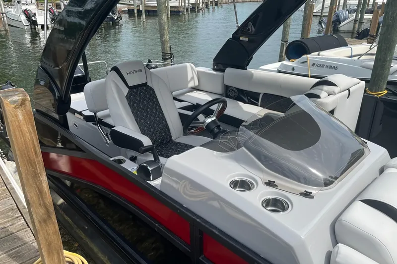 Slide: The Image of 2024 Harris Grand Mariner 250 boat interior with sleek seating and modern dashboard. - 21