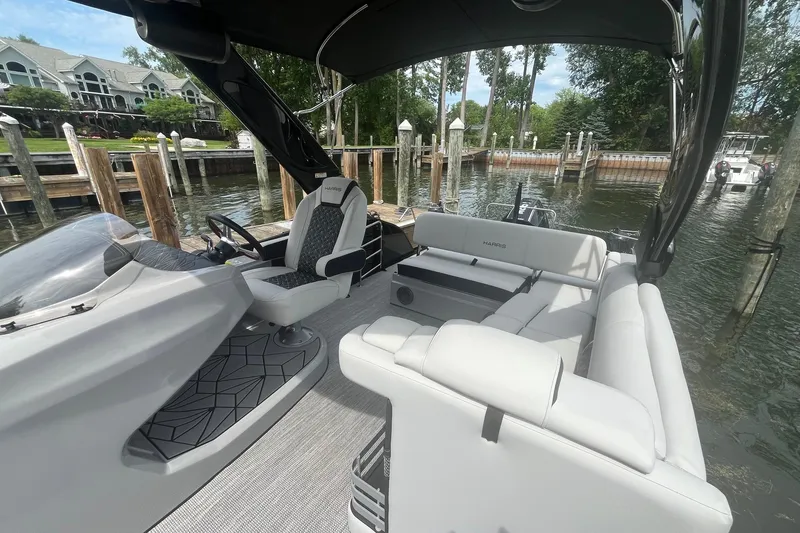 Slide: The Image of 2024 Harris Grand Mariner 250 pontoon boat interior with luxurious seating and modern design. - 19