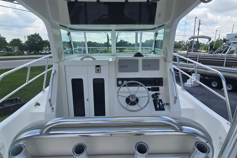 Slide: The Image of 2003 True World Marine 286 boat cockpit with steering wheel and control panel. - 9