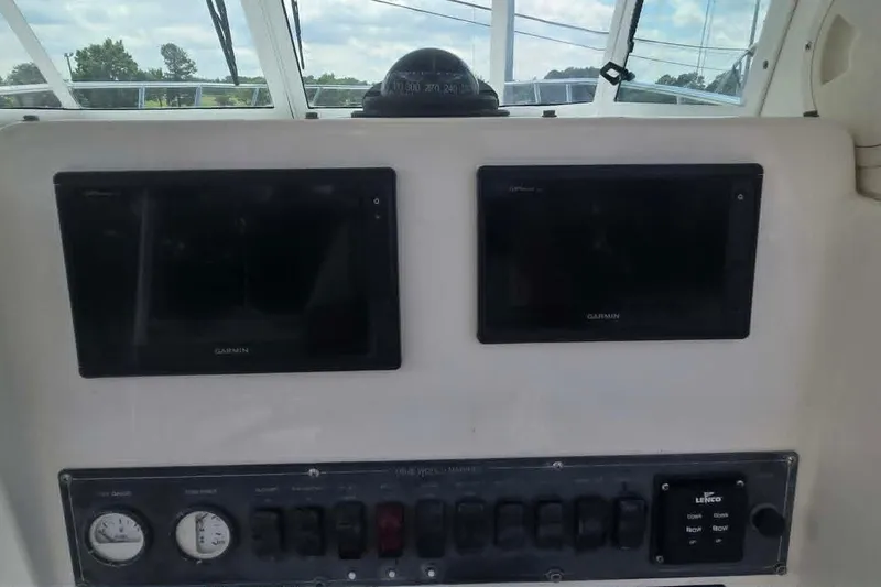 Slide: The Image of Control panel of a 2003 True World Marine 286 boat with Garmin displays. - 11