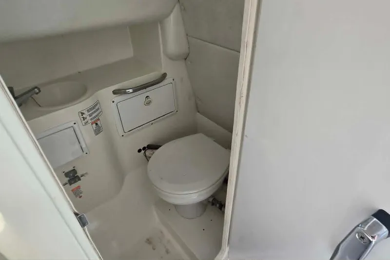 Slide: The Image of Compact marine bathroom in 2003 True World Marine 286 boat, featuring toilet and sink. - 16