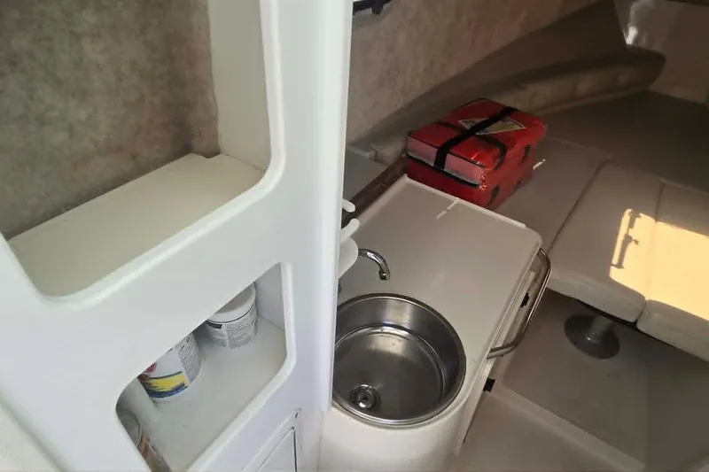 Slide: The Image of Interior of 2003 True World Marine 286 boat with sink and seating area. - 15