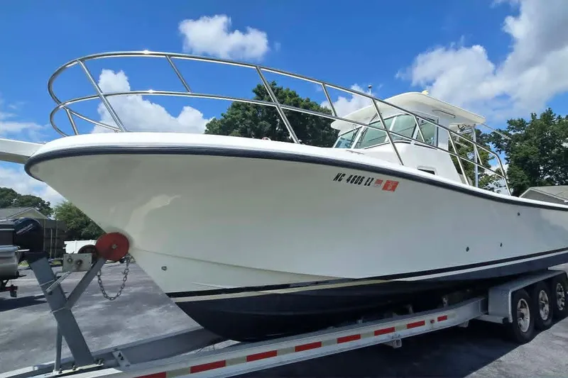 Slide: The Image of 2003 True World Marine 286 boat on trailer under clear blue sky. - 3