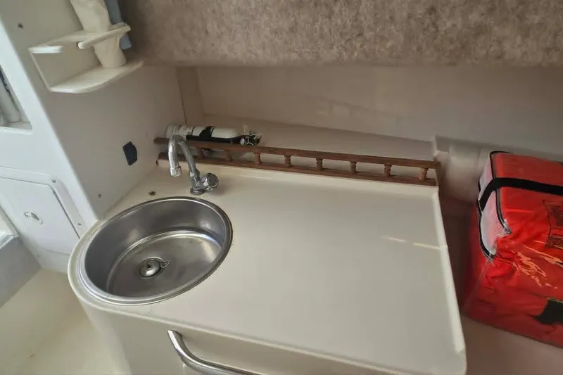 Slide: The Image of 2003 True World Marine 286 boat interior with sink and storage area. - 17