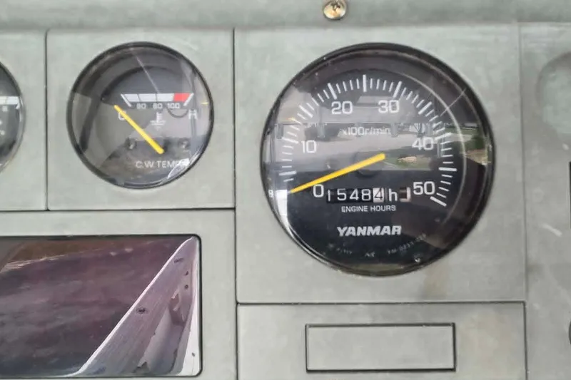Slide: The Image of Instrument panel of a 2003 True World Marine 286 boat, showing engine hours and temperature gauges. - 13