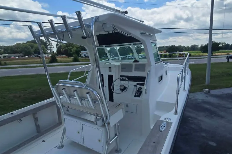 Slide: The Image of 2003 True World Marine 286 boat with helm station, outdoor seating, and rod holders. - 8