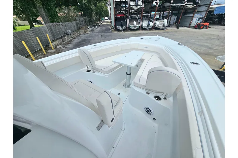 Slide: The Image of 2026 Sea Hunt Gamefish 30 Forward Seating boat interior with white seating and table. - 33