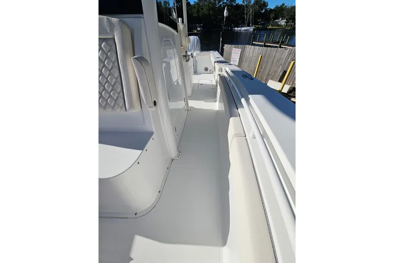 Slide: The Image of 2026 Sea Hunt Gamefish 30 Forward Seating boat interior with white upholstery. - 38