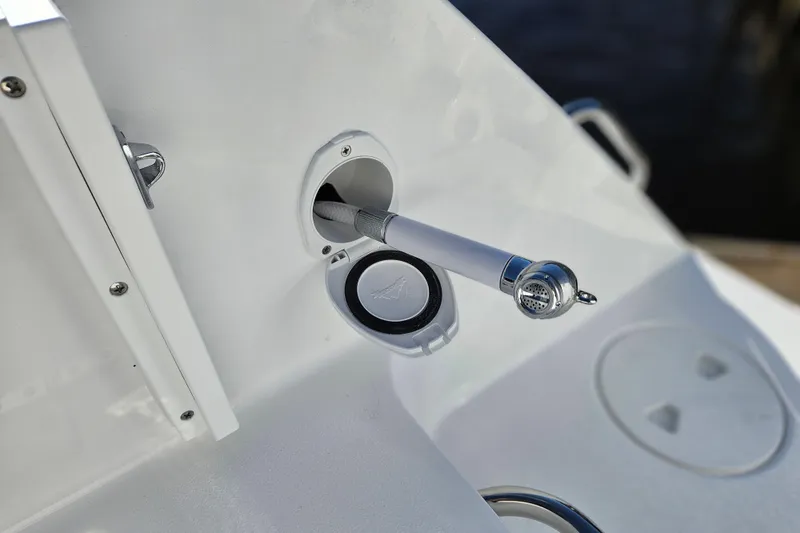 Slide: The Image of 2026 Sea Hunt Gamefish 30 boat detail, featuring a retractable hose and nozzle. - 13
