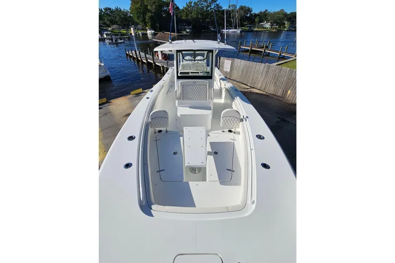 Slide: The Image of 2026 Sea Hunt Gamefish 30 Forward Seating boat at dock, showcasing spacious deck design. - 41