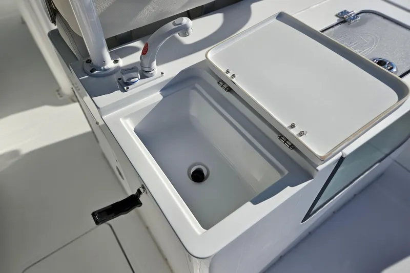 Slide: The Image of 2026 Sea Hunt Gamefish 30 boat sink and faucet detail, forward seating area. - 17
