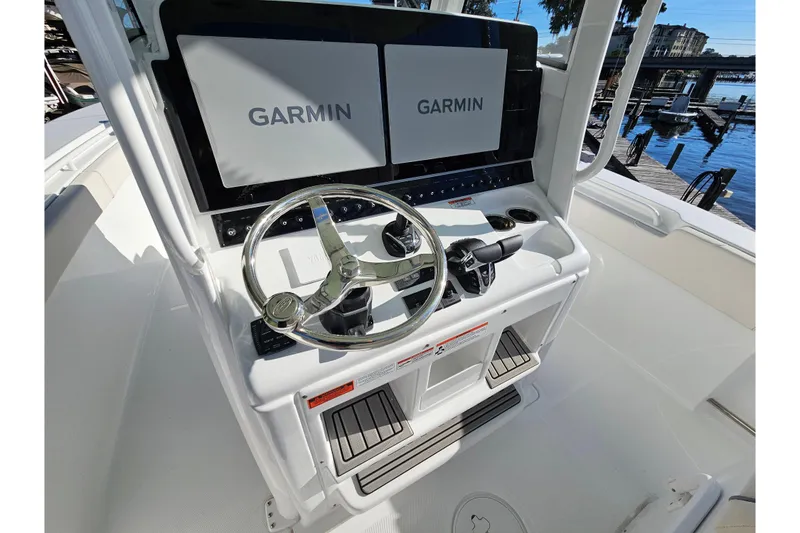 Slide: The Image of 2026 Sea Hunt Gamefish 30 helm with dual Garmin displays and steering wheel. - 26