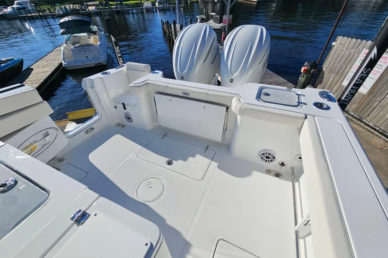 Slide: The Image of 2026 Sea Hunt Gamefish 30 boat with forward seating, docked with twin engines. - 8