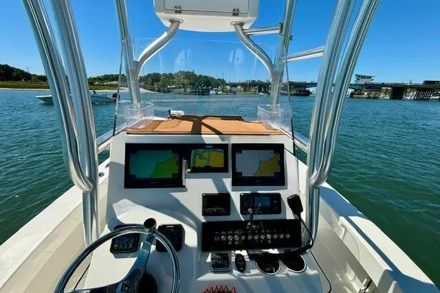 Slide: The Image of Center console of a 2021 Tideline 235 boat with navigation screens and controls. - 7