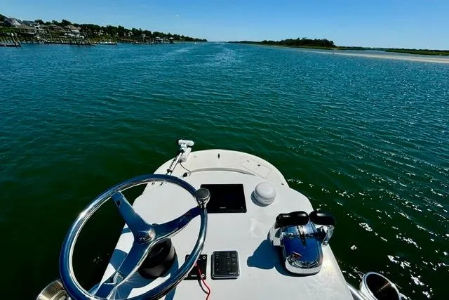 Slide: The Image of Steering view from a 2021 Tideline 235 boat on a calm, sunny waterway. - 5