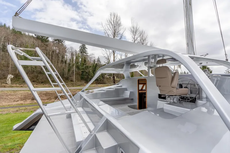 Slide: The Image of 2025 Shuttleworth 52 AeroRig yacht with sleek design and modern cockpit, set against a wooded backdrop. - 8