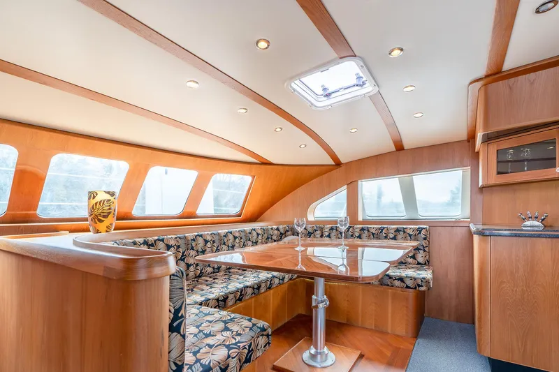 Slide: The Image of Luxurious interior of 2025 Shuttleworth 52 AeroRig yacht with elegant wood finish and seating. - 22