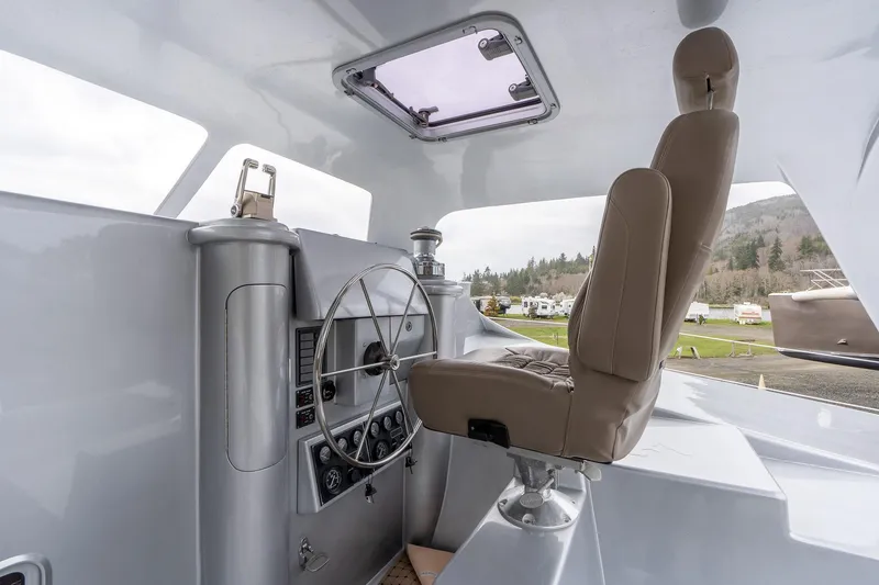 Slide: The Image of Interior cockpit of 2025 Shuttleworth 52 AeroRig yacht, featuring modern steering and controls. - 19