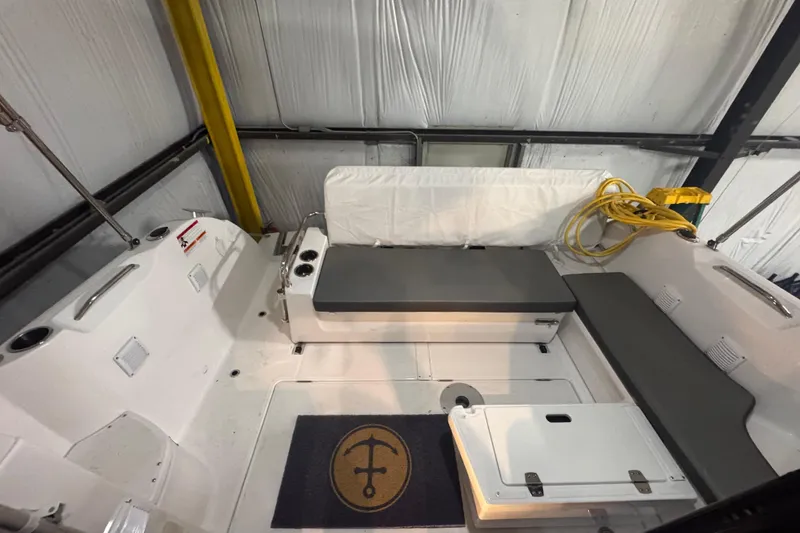 Slide: The Image of 2024 Beneteau Antares 9 boat interior with seating and storage in a warehouse. - 6