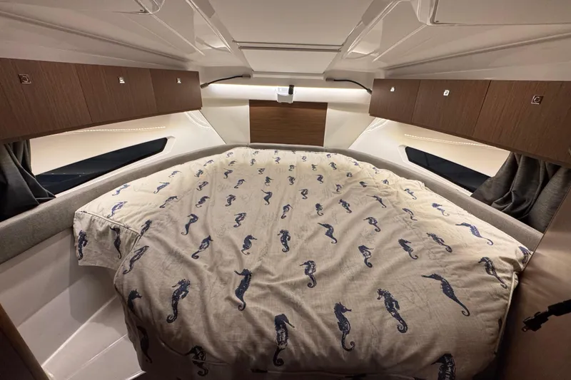 Slide: The Image of Cozy cabin interior of 2024 Beneteau Antares 9 with seahorse-patterned bedding. - 18