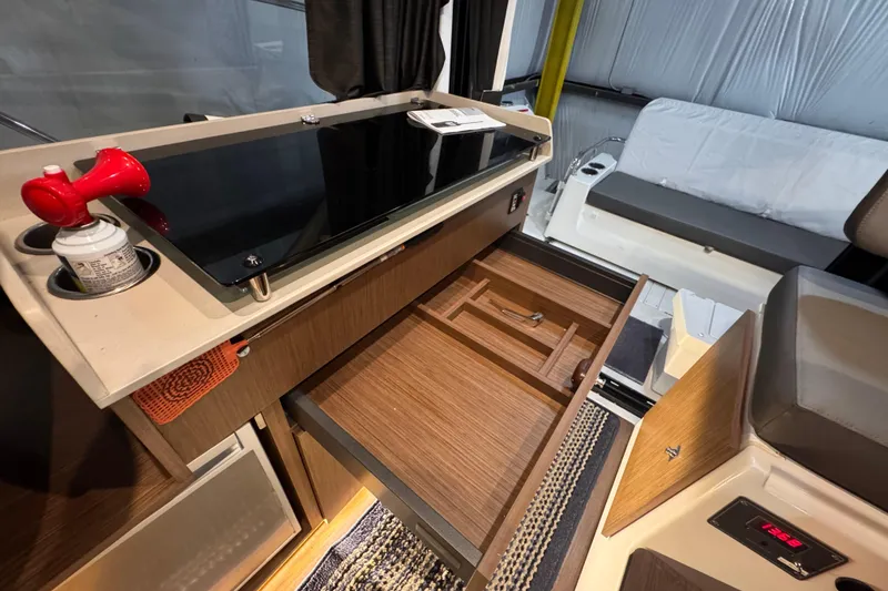 Slide: The Image of Interior of 2024 Beneteau Antares 9, featuring a sleek kitchen area with open storage. - 12