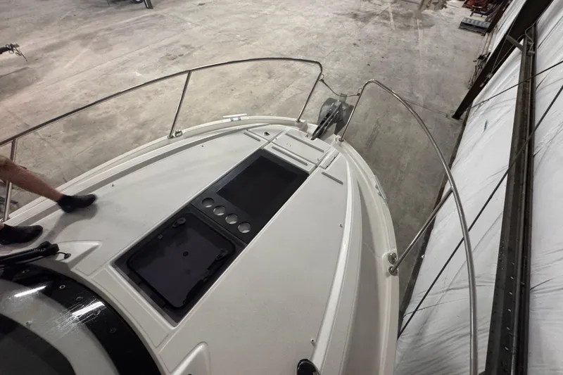 Slide: The Image of 2024 Beneteau Antares 9 boat deck in a warehouse setting. - 26