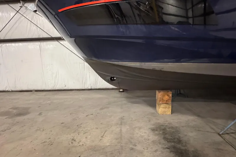 Slide: The Image of 2024 Beneteau Antares 9 boat hull in a warehouse setting. - 24