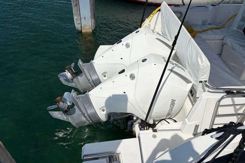 Slide: The Image of Twin Mercury outboard engines on a 2024 Beneteau Antares 9, docked in clear water. - 3