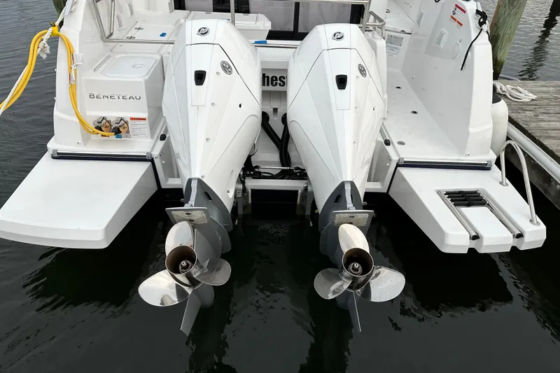 Slide: The Image of 2024 Beneteau Antares 9 boat with dual outboard engines at dock. - 2