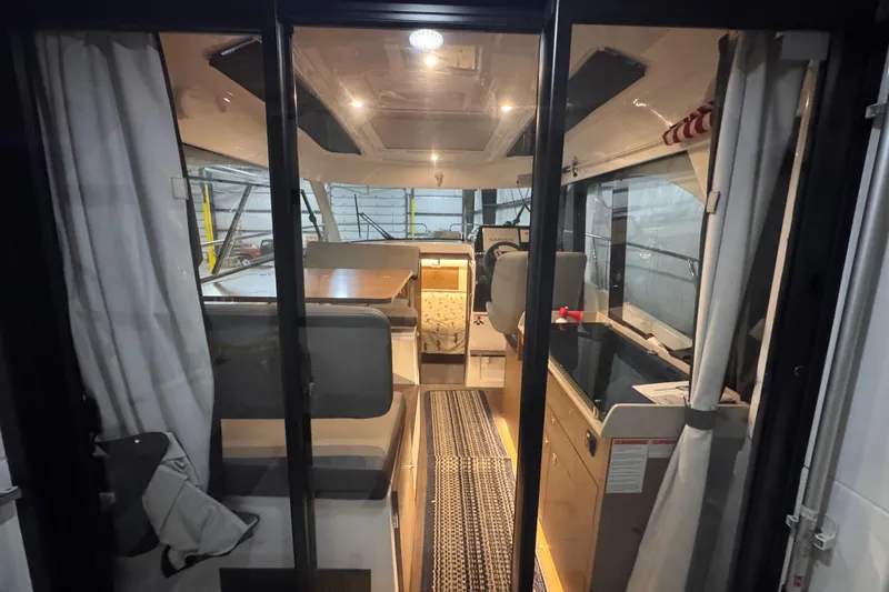 Slide: The Image of Interior view of 2024 Beneteau Antares 9 boat, featuring seating and navigation area. - 7