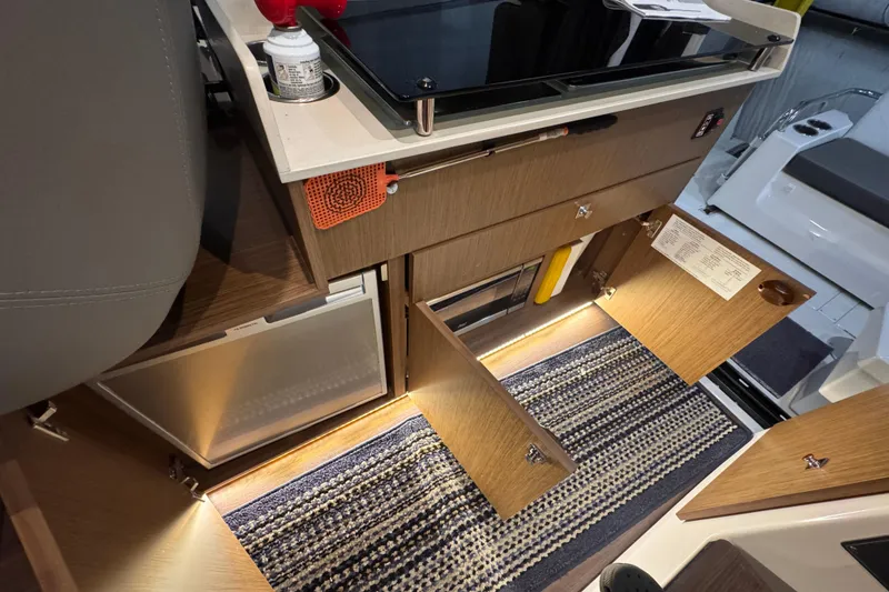 Slide: The Image of Interior of 2024 Beneteau Antares 9 with open cabinets and modern design. - 11