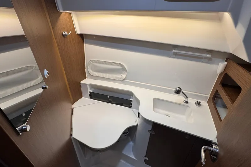 Slide: The Image of 2024 Beneteau Antares 9 bathroom with modern fixtures and wood accents. - 16