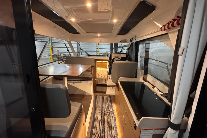 Slide: The Image of Interior of 2024 Beneteau Antares 9 boat, featuring modern seating and navigation area. - 8