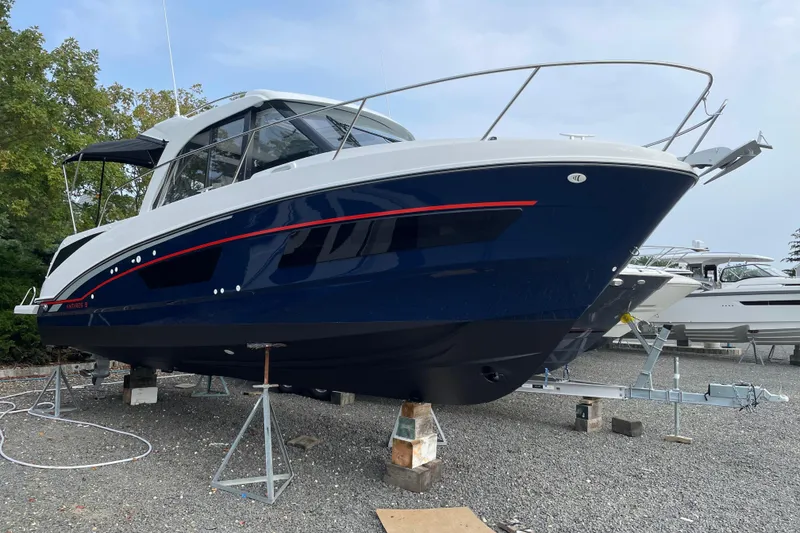 Slide: The Image of 2024 Beneteau Antares 9 boat on stands, blue hull, sleek design, outdoor setting. - 3