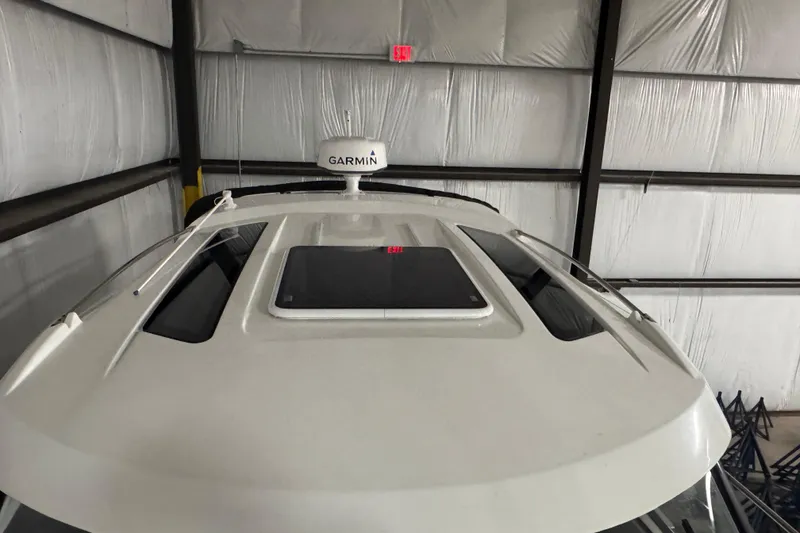 Slide: The Image of 2024 Beneteau Antares 9 boat roof with Garmin radar in a storage facility. - 27