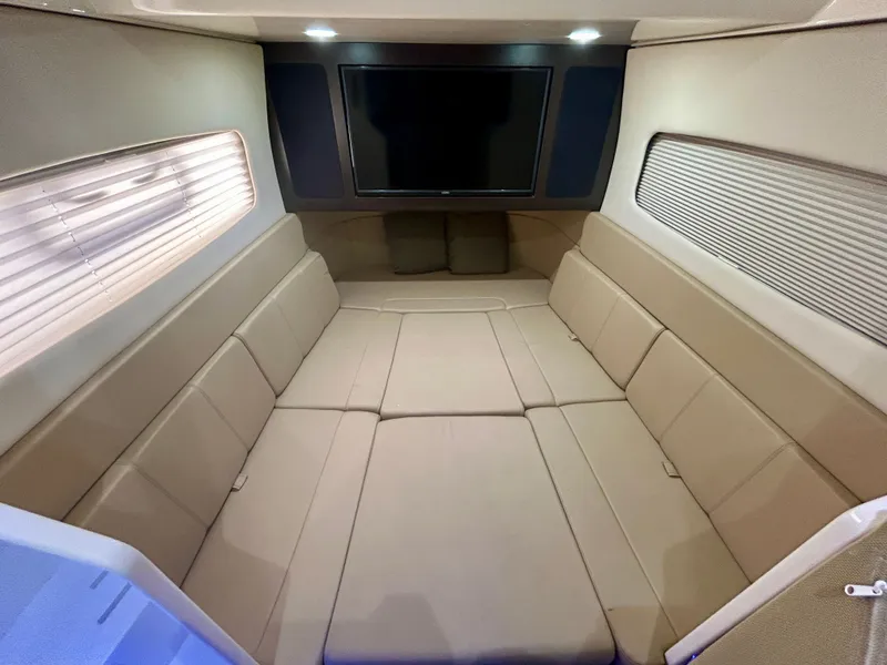 Slide: The Image of Interior of a modern boat cabin with beige upholstery and a large TV on the wall. - 18