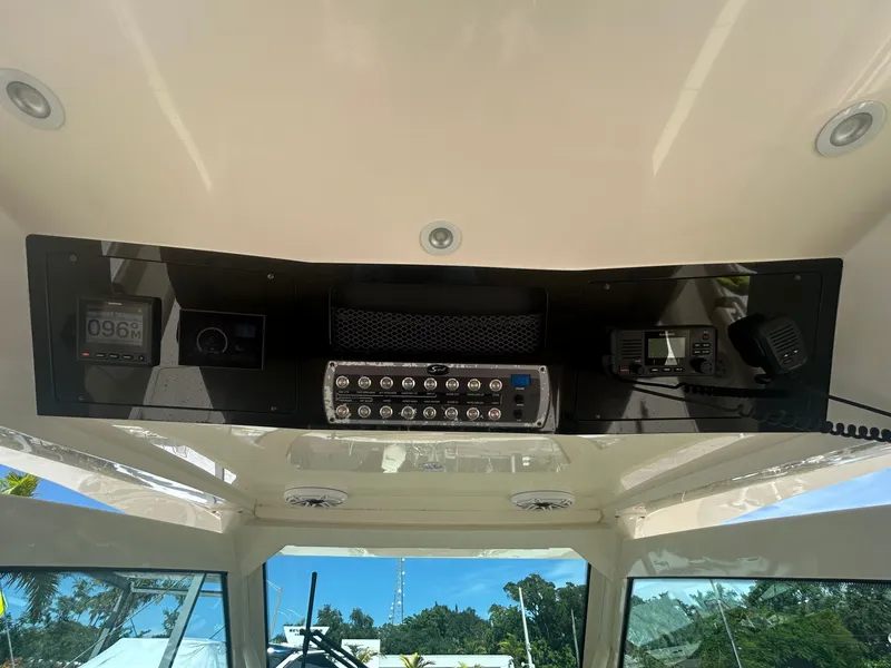Slide: The Image of The image shows the dashboard of a 2021 Scout 380 boat with various instruments. - 19