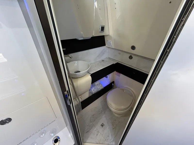 Slide: The Image of The image shows a modern boat bathroom with a sink and toilet. - 15