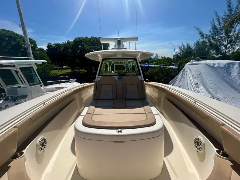 Slide: The Image of 2021 Scout 380 with spacious deck and comfortable seating, surrounded by trees. - 12